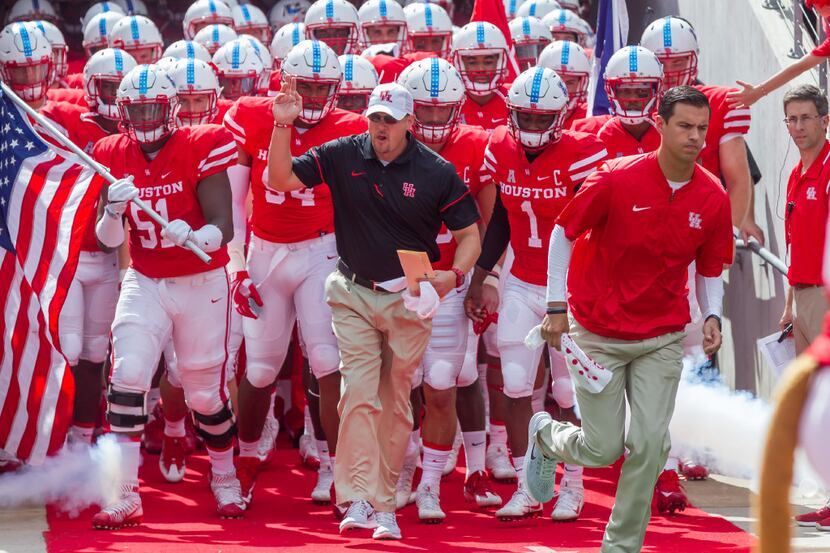 FILE - 10 September, 2016: Houston Cougars head coach Tom Herman leads the team onto the...