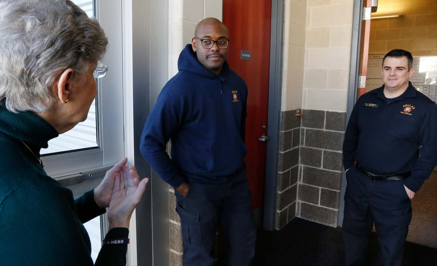 Feed-A-Hero volunteer Andrea Wolf, left, thank Dallas firefighters Chuck Phillips, II, ...