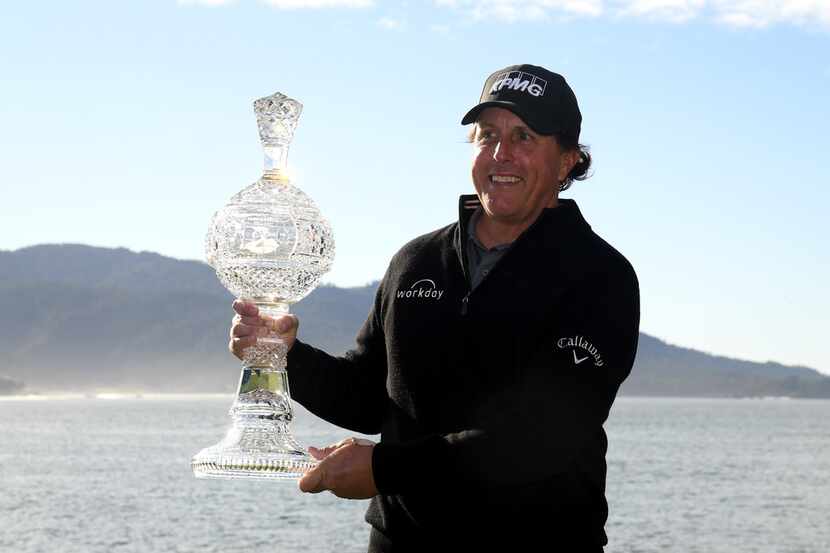 PEBBLE BEACH, CALIFORNIA - FEBRUARY 10:  Phil Mickelson poses with the trophy after his...
