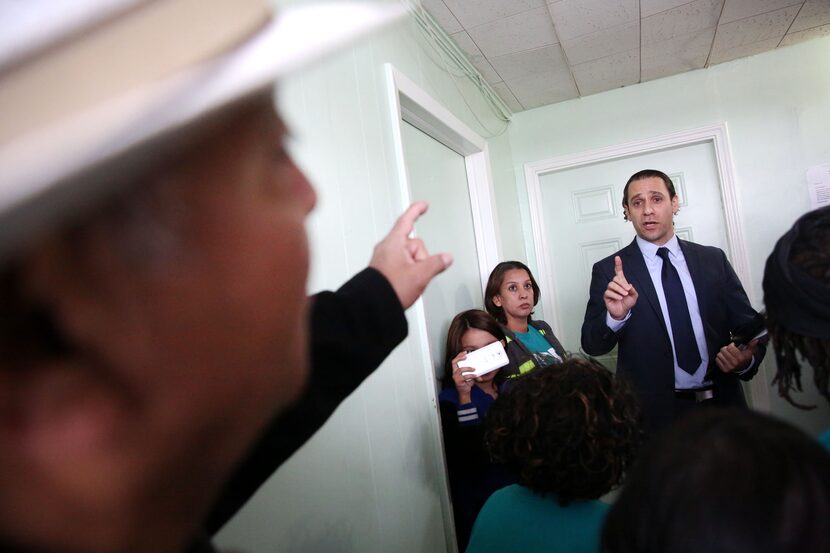 HMK landlord Khraish Khraish (right) speaks back and forth with HMK tenant Joe Garcia after...