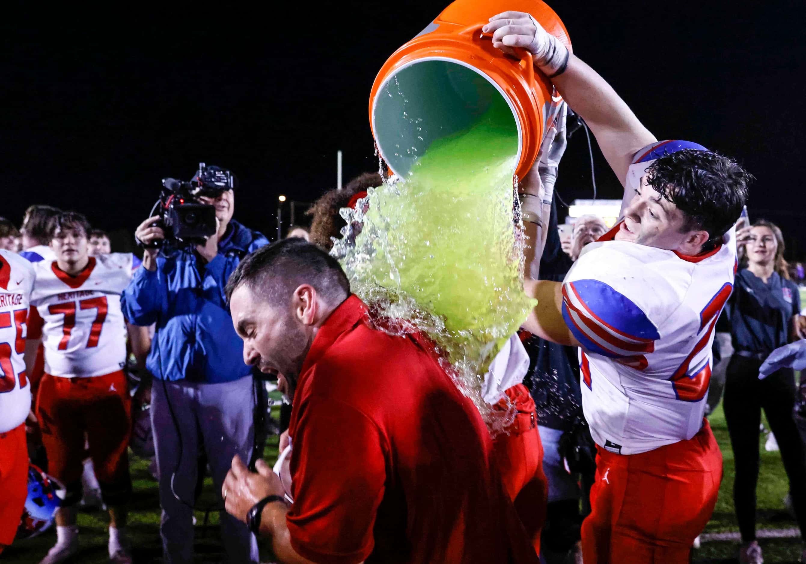 Midlothian Heritage high players dumps gatorade on head coach Eric Edwards after winning the...