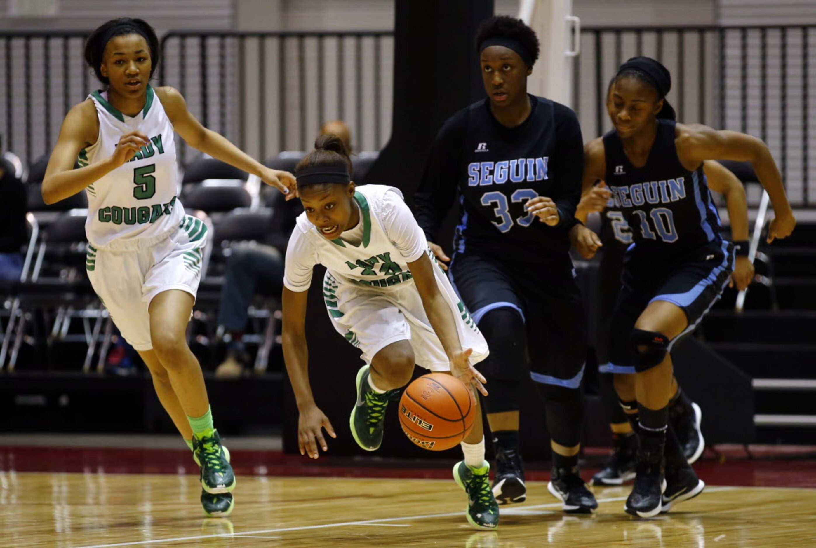 Bryan Adams' Alexxus Gilbert (12) pushes the ball up the court as Fabrianna Dixon (5),...