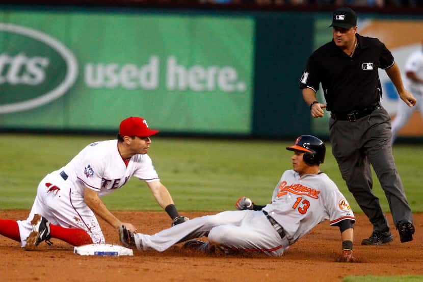 Baltimore's Manny Machado (13) is called out as he tries to take second base in the top of...