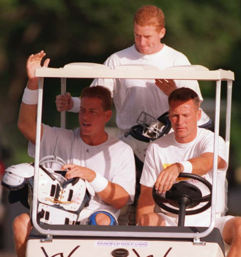 The Dallas Cowboys quarterbacks Troy Aikman (seated-left), Wade Wilson (seated-right) and...