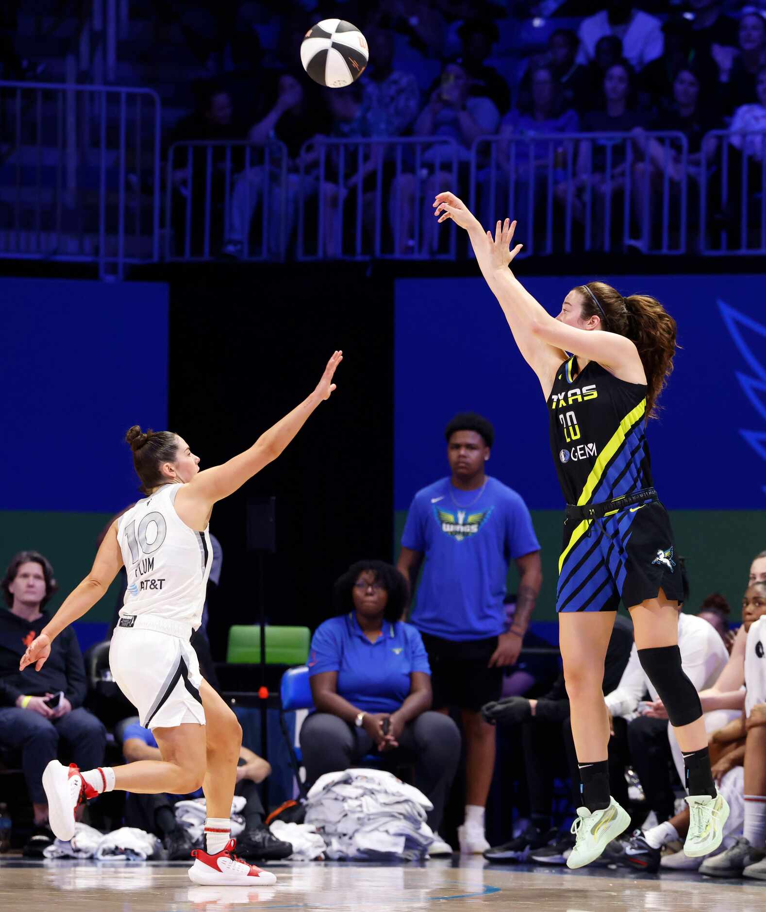 Dallas Wings forward Maddy Siegrist (right) shoots over Las Vegas Aces guard Kelsey Plum...