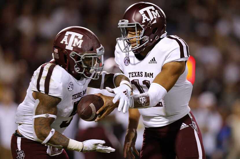 STARKVILLE, MS - OCTOBER 27: Kellen Mond #11 of the Texas A&M Aggies hands the ball to...