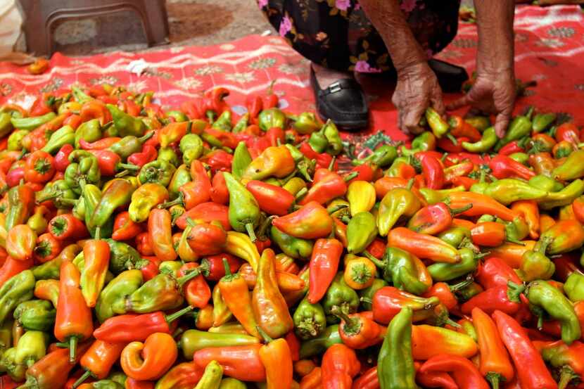 A vendor sorts chiles at the post in Tlacolula market in Tlacolula, Oaxaca on March 7, 2010....