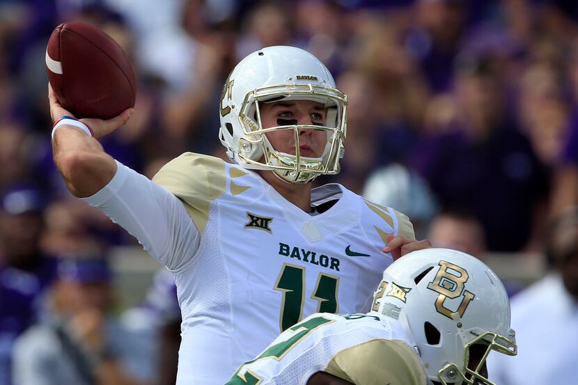 Baylor quarterback Zach Smith (11) throws a pass during the first half of an NCAA college...