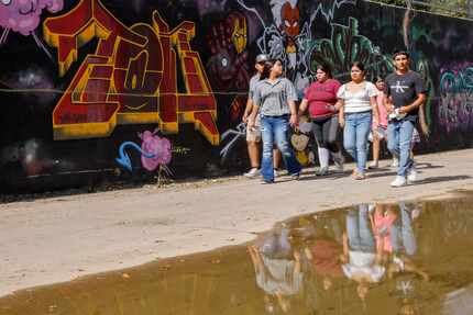 People walk through “The Walls” during Styles Fest in Pleasant Grove on Oct. 15 in Dallas.