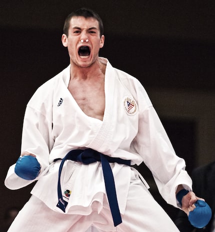 Tom Scott celebrates after winning the gold medal match against a competitor from the...