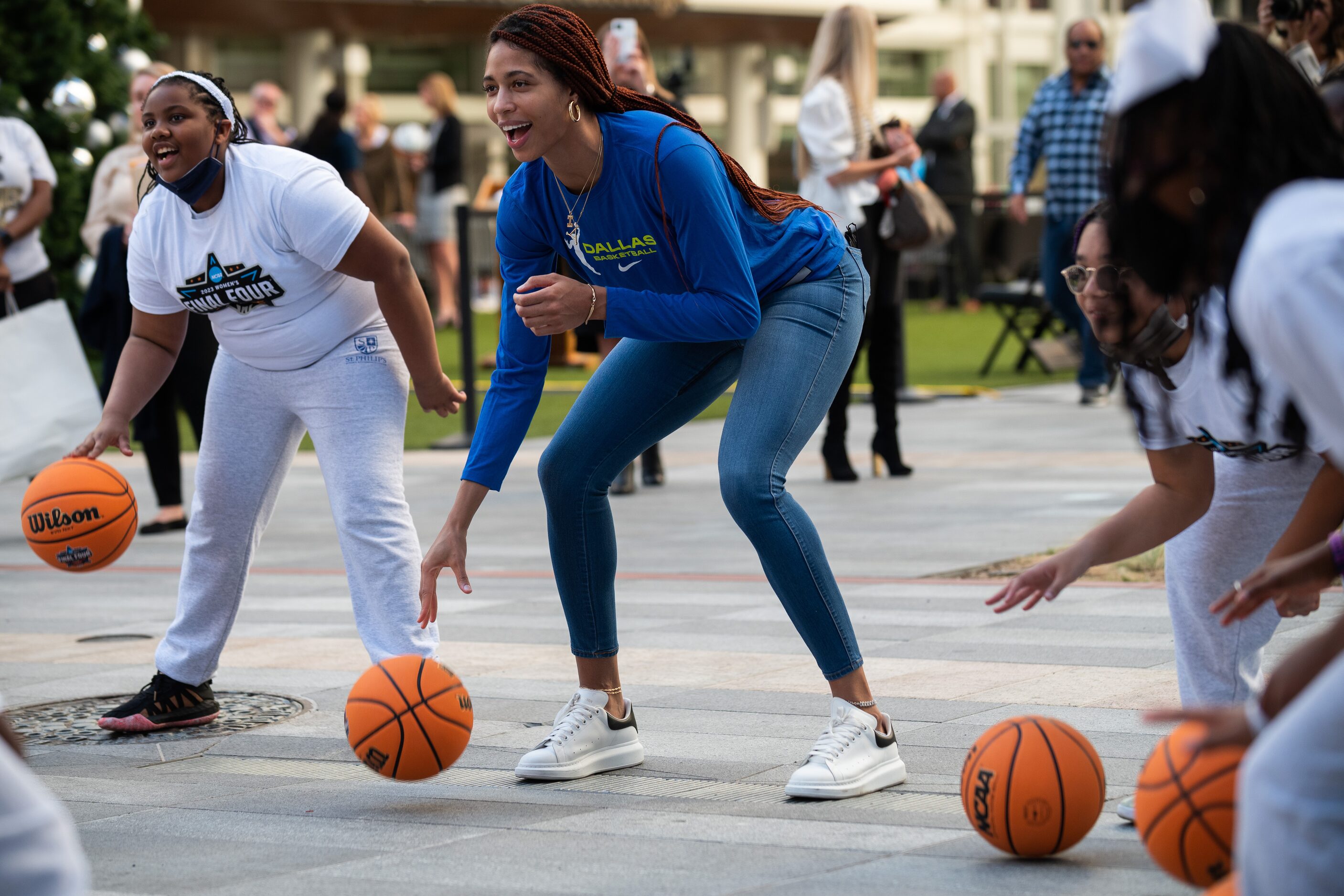 Eden Murrell, 11, left, of St. Philip's School and Community Center, conducts a basketball...