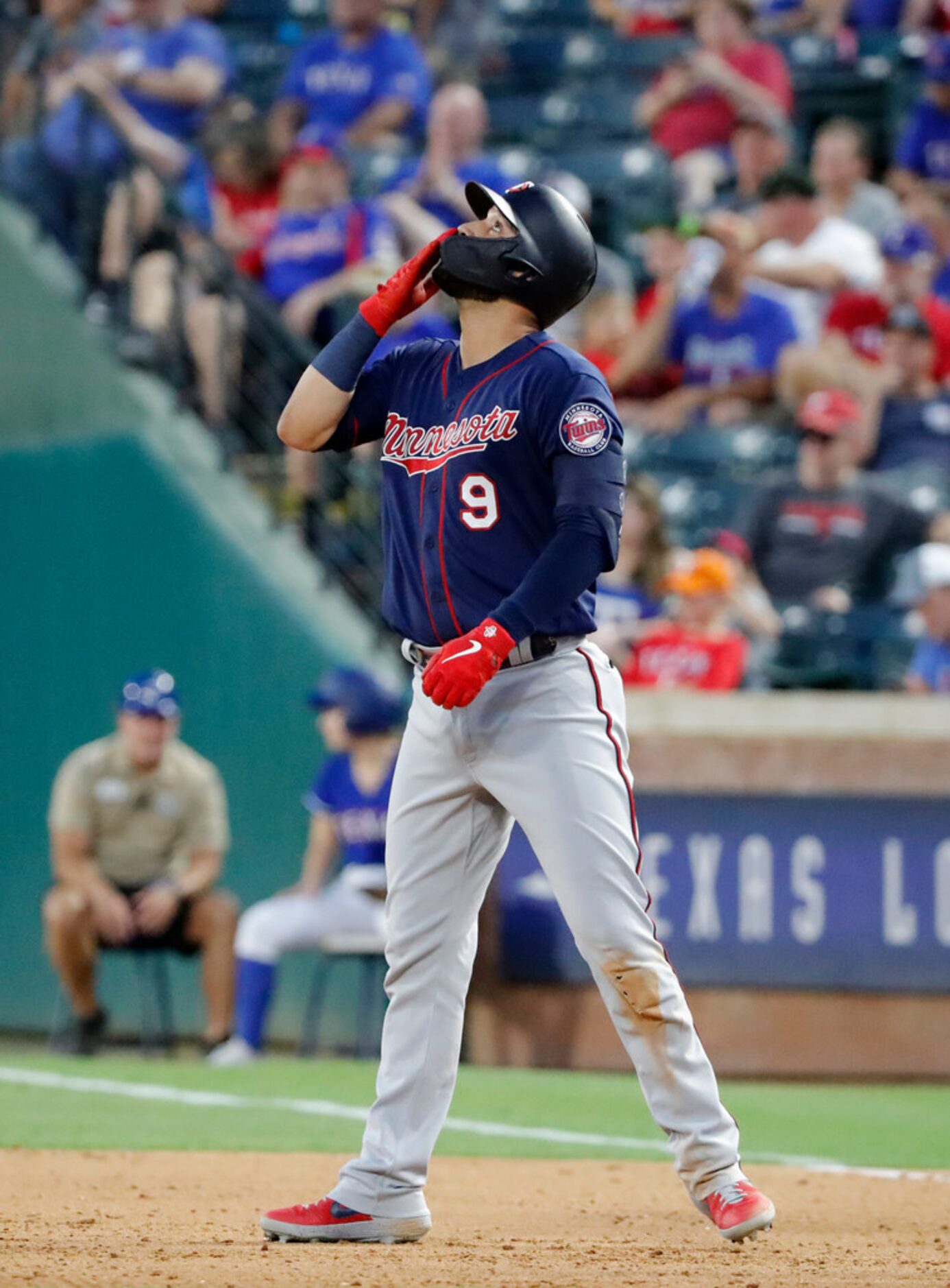 Minnesota Twins' Marwin Gonzalez gestures skyward after hitting a single in the fourth...