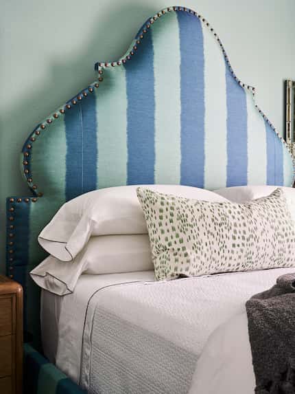 Designer Denise McGaha makes up a bed at her home in Grapevine with white sheets that have...