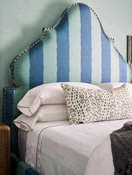 Designer Denise McGaha makes up a bed at her home in Grapevine with white sheets that have...