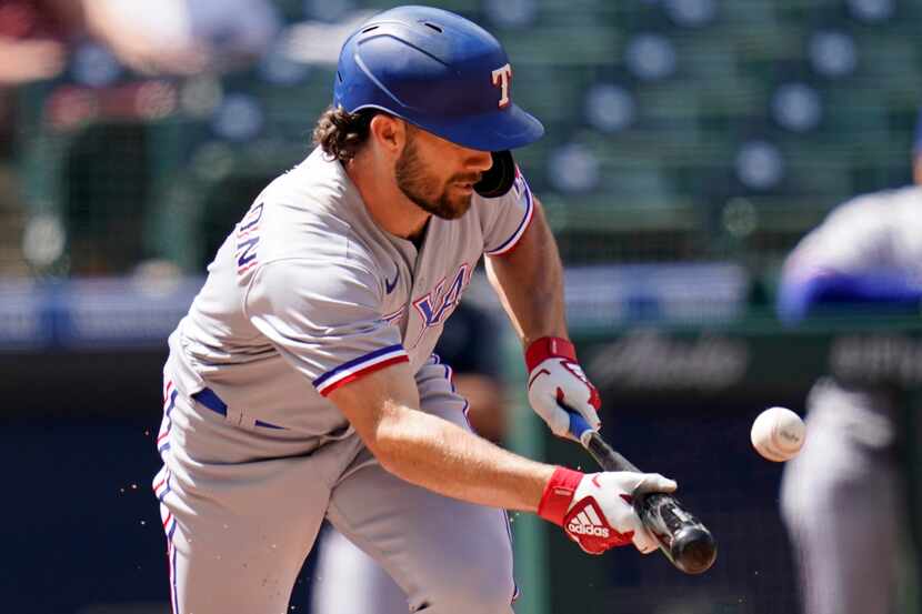 Texas Rangers' Charlie Culberson attempts a bunt against the Seattle Mariners in the fifth...