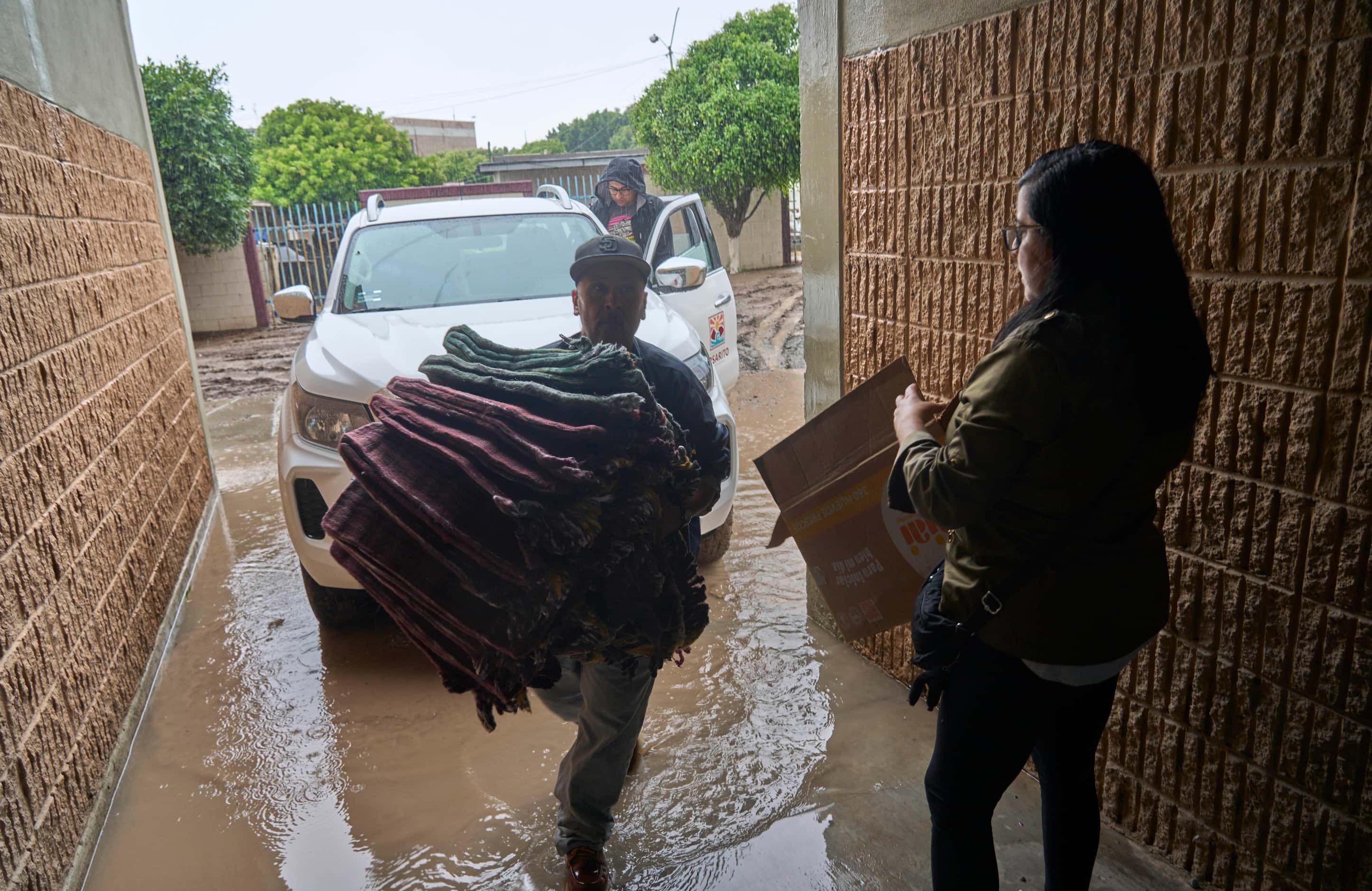 Authorities bring food and supplies for a shelter after the landfall of Tropical Storm...