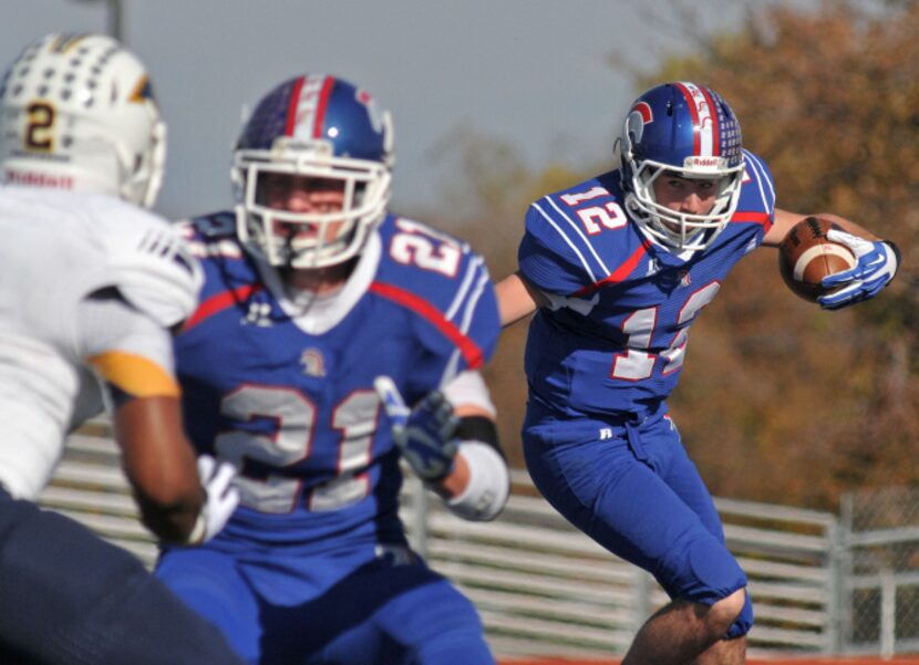 TCA - Addison sophomore Parker Oliver (12) counts on the block of senior Drue Allen (21)...