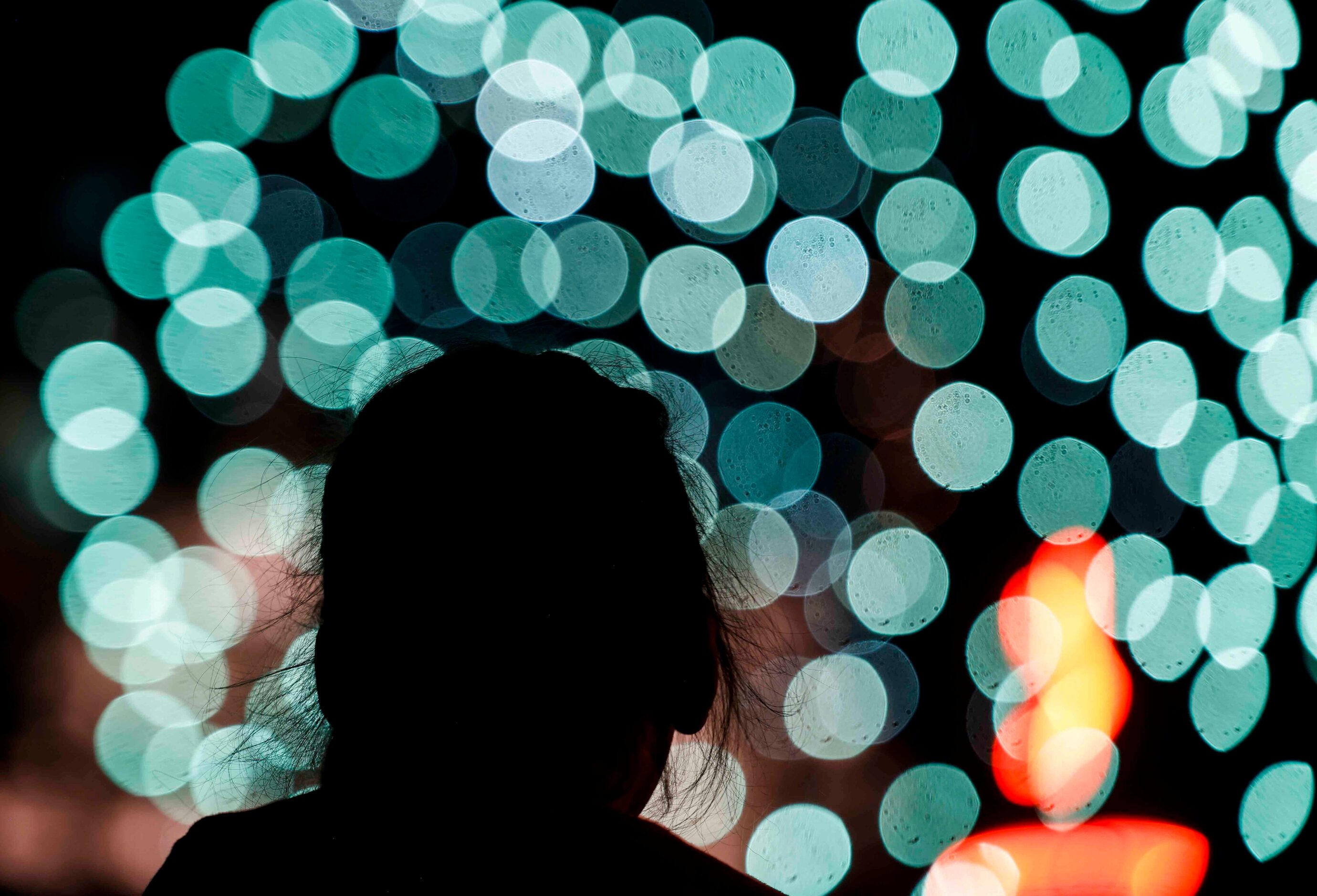 Adelayda Countino, 5, is silhouetted against the fireworks during an Independence Day...