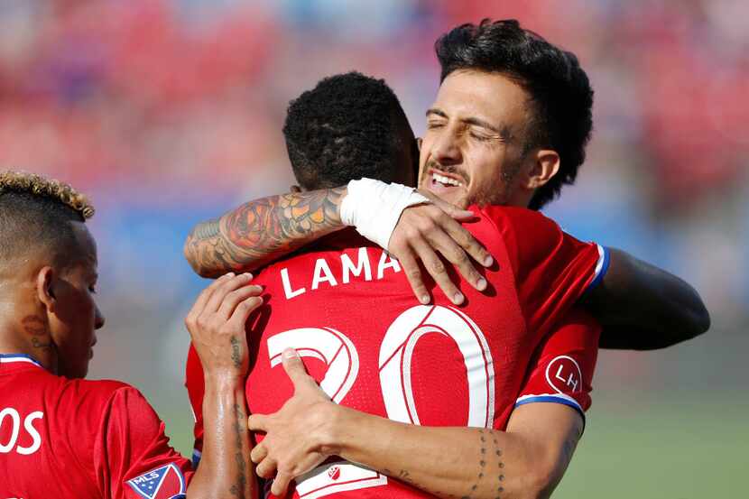 FC Dallas forward Roland Lamah (20) and FC Dallas forward Maximiliano Urruti (37) celebrate...