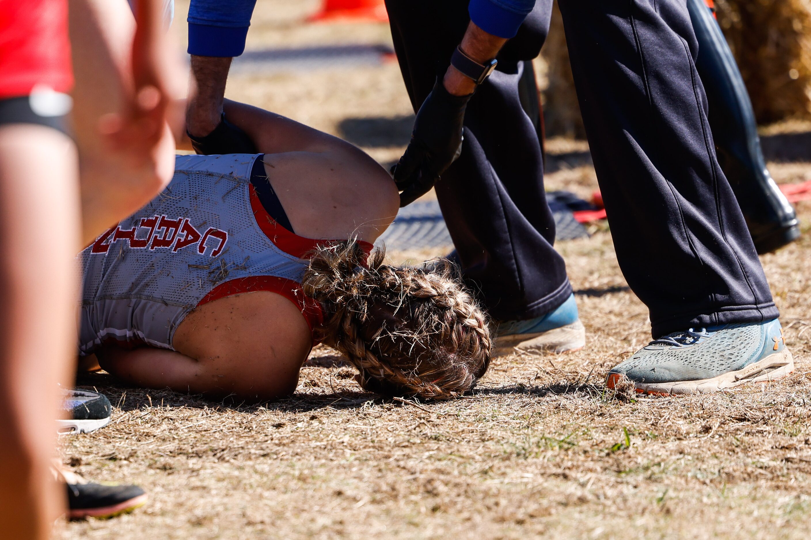 Hallie Hendrickson (1605) from Melissa team collapses after crossed the finish line during...