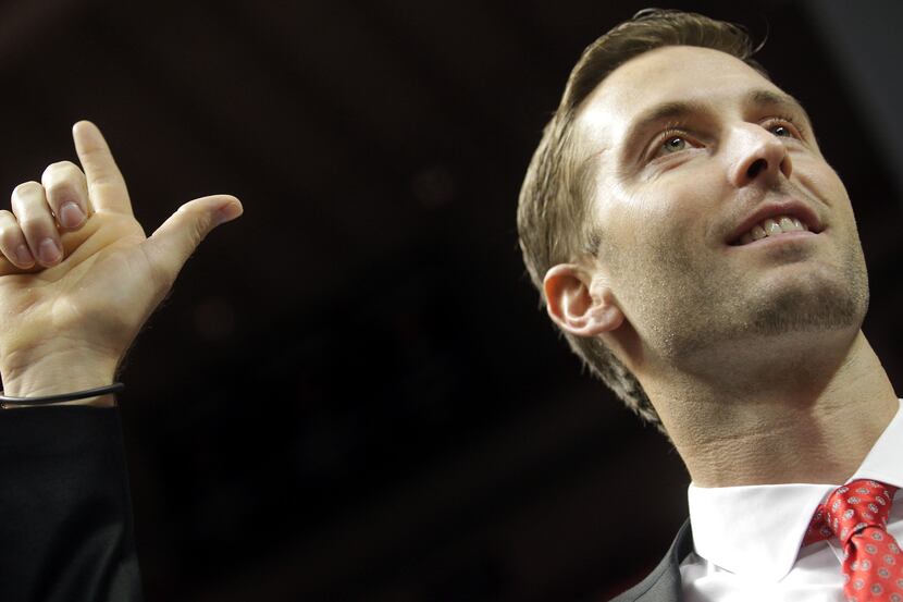 Texas Tech head coach Kliff Kingsbury gives the guns up sign during his introductory press...