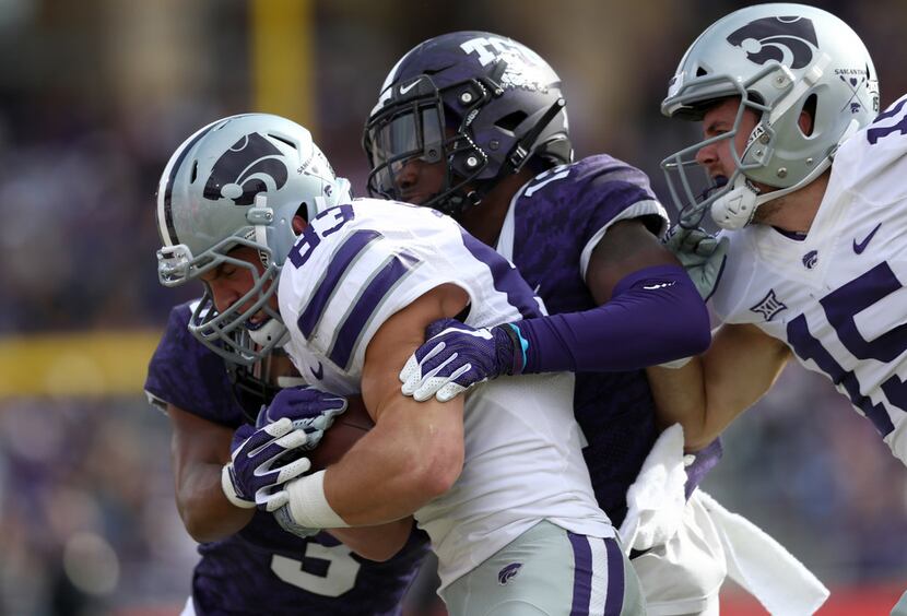 FORT WORTH, TEXAS - NOVEMBER 03:  Dalton Schoen #83 of the Kansas State Wildcats is tackled...
