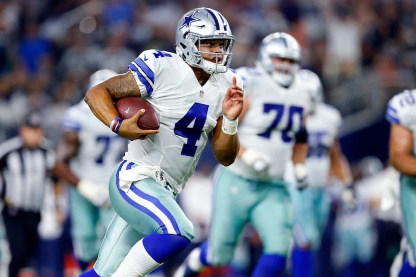 Dallas Cowboys quarterback Dak Prescott (4) takes off running after not finding an open...