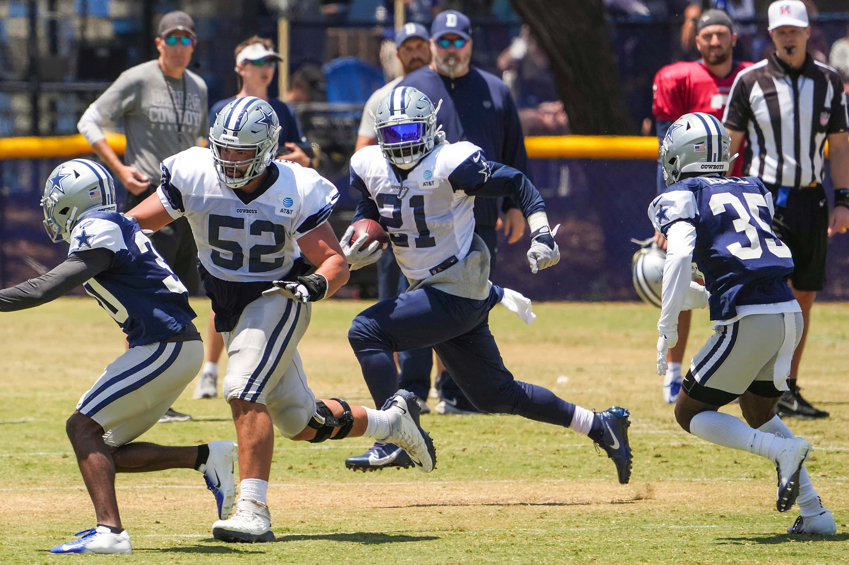 Dallas Cowboys running back Ezekiel Elliott (21) gets a block from guard Connor Williams...