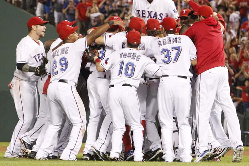 FILE - Texas OF Nelson Cruz celebrates winning the AL Championship with teammates after Game...