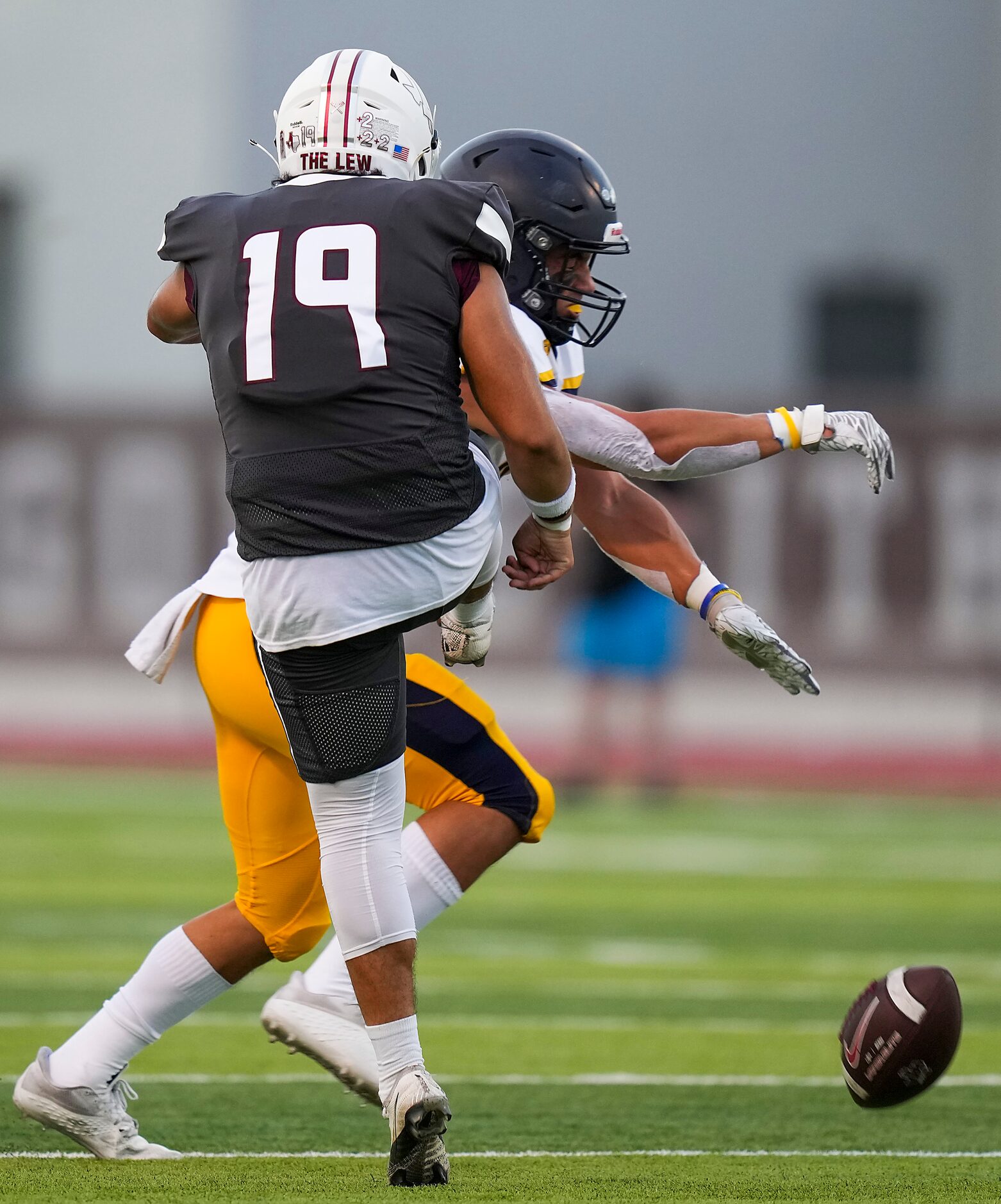 Highland Park’s Adam Rourke (9) blocks a punt by Lewisville’s Freddy Joya (19) during the...