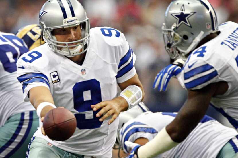 Dallas Cowboys quarterback Tony Romo (9) hands off to running back Phillip Tanner during the...