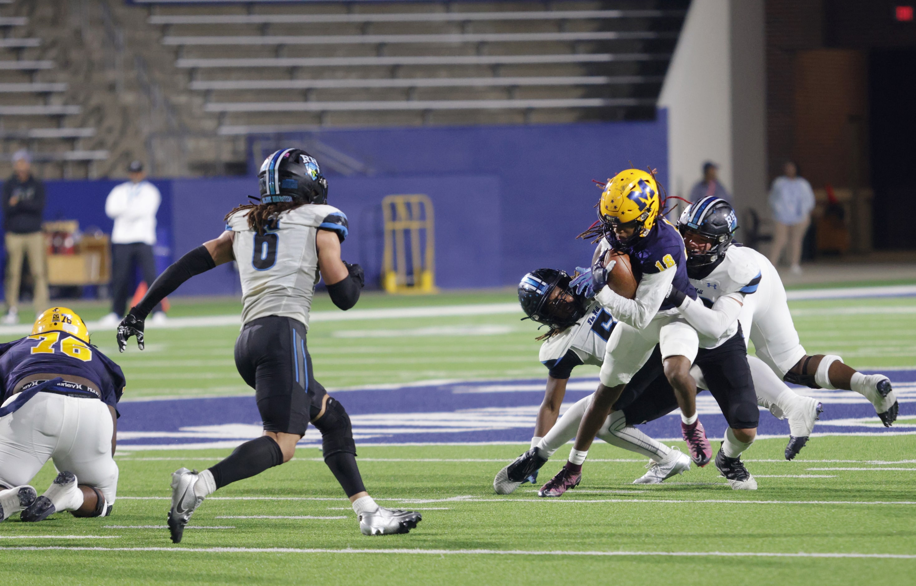 McKinney player #18 Jacoby Propes is pulled down during the Prosper Rock Hill High School...