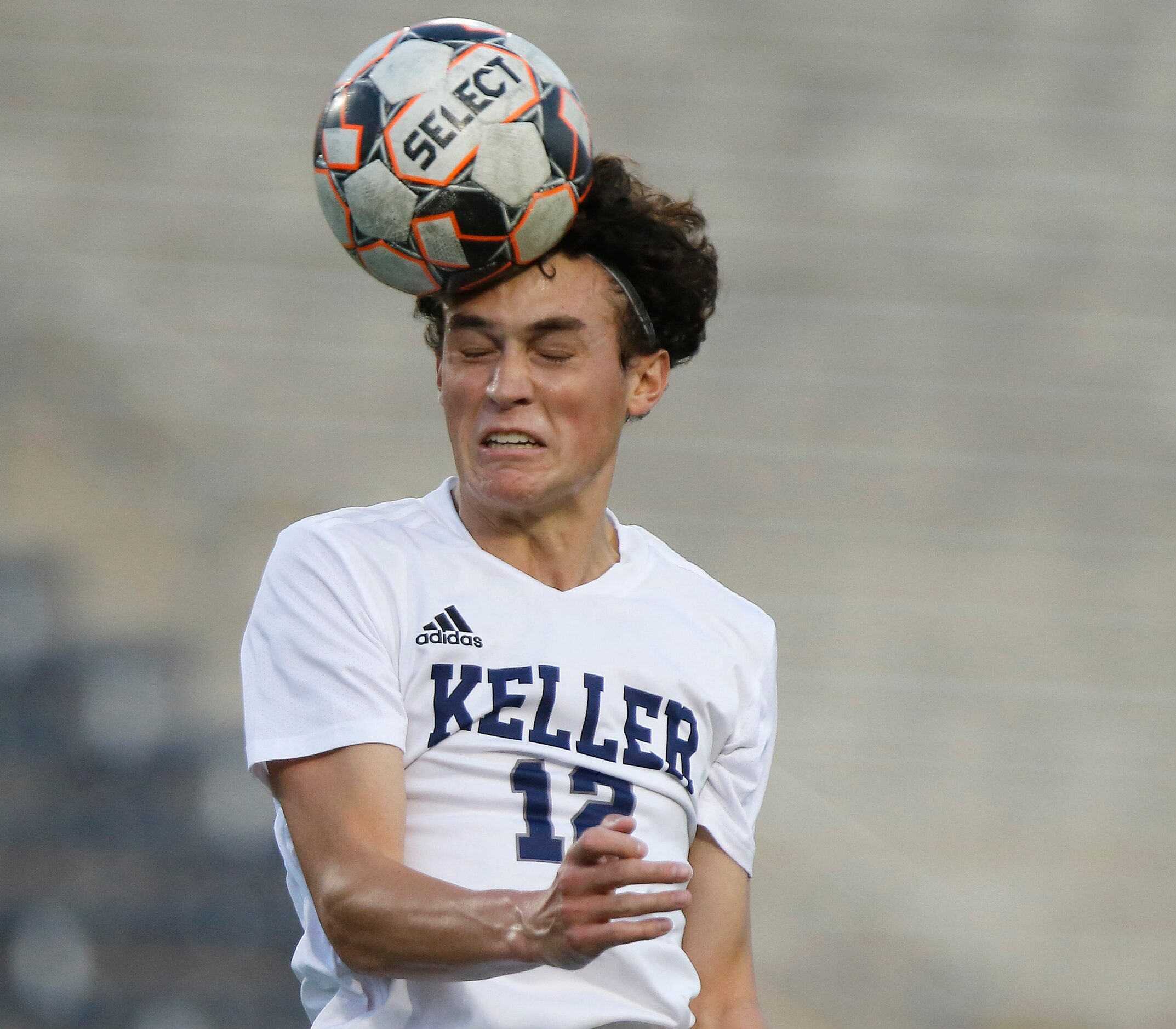 Keller forward Conner Lisenbee (12) gets a header during the first half as Allen High School...