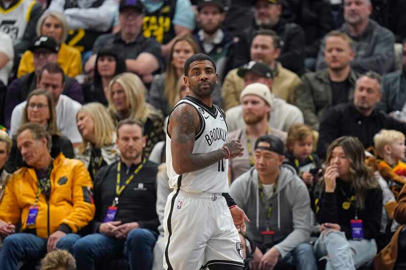 Brooklyn Nets guard Kyrie Irving (11) looks on during the first half of an NBA basketball...