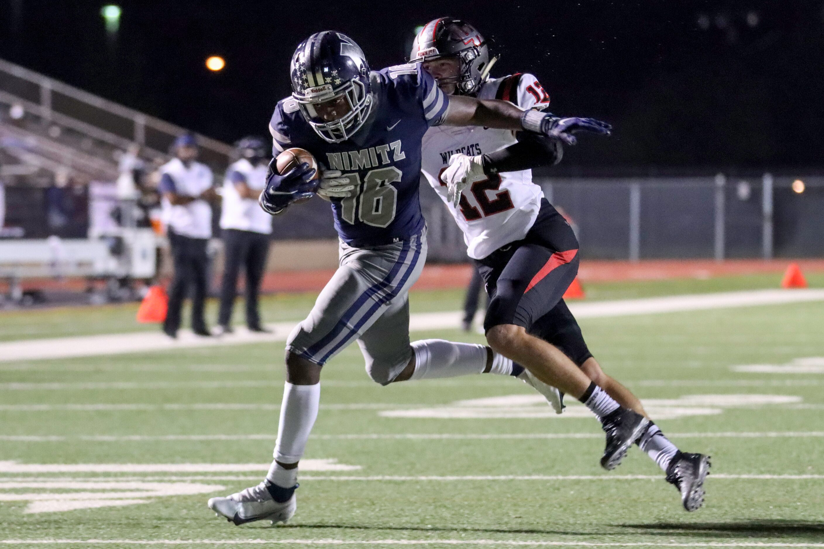 Lake Highlands defensive back Carson Klein (12) tackles Irving Nimitz wide receiver Chris...