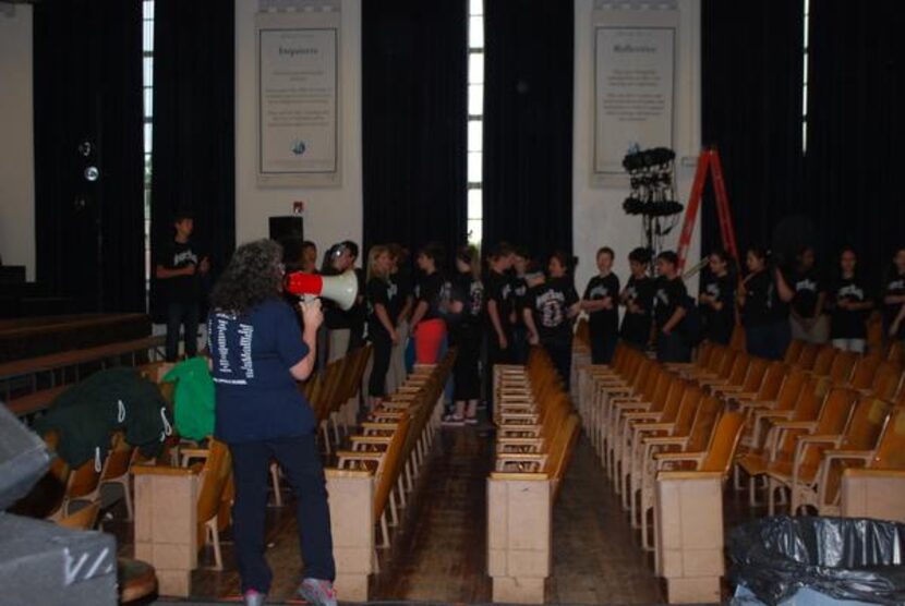 
Beverly Hirsch (left) uses a megaphone to give directions to students in Super Rock, a...