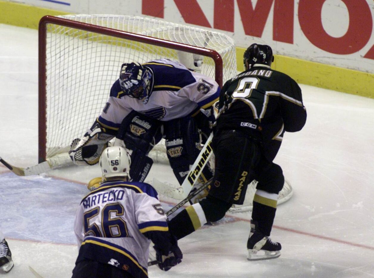 Dallas Stars Mike Modano shoots his overtime goal on St. Louis Blues goalie Grant Fuhr in...