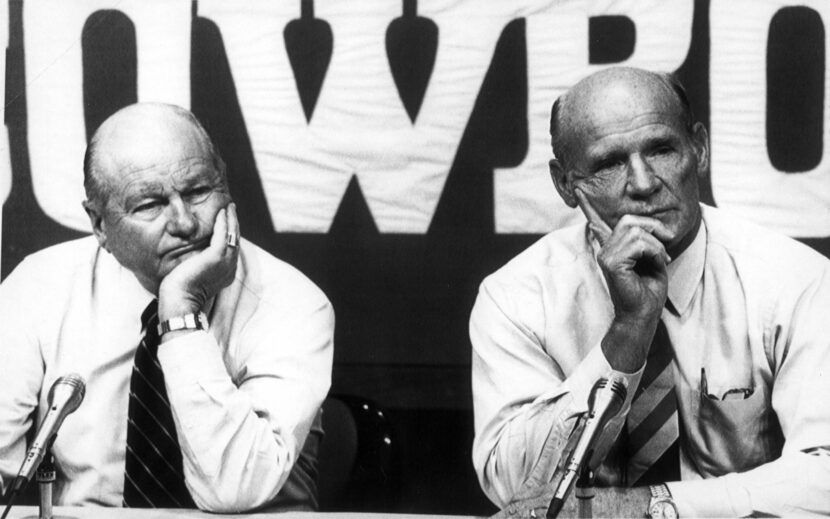 Cowboys President and General Manager Tex Schramm (left) and Head Coach Tom Landry listen to...