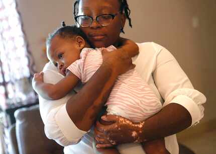 Y'Tesia Taylor holds her youngest child, Amaya Smith, 1, at their home in Greenville, Texas...