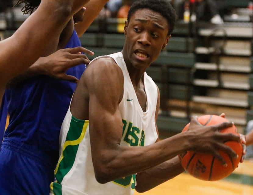 Duncanville vs DeSoto's Jahmar Young (30) is stopped by Duncanville in District 7-6A boys...