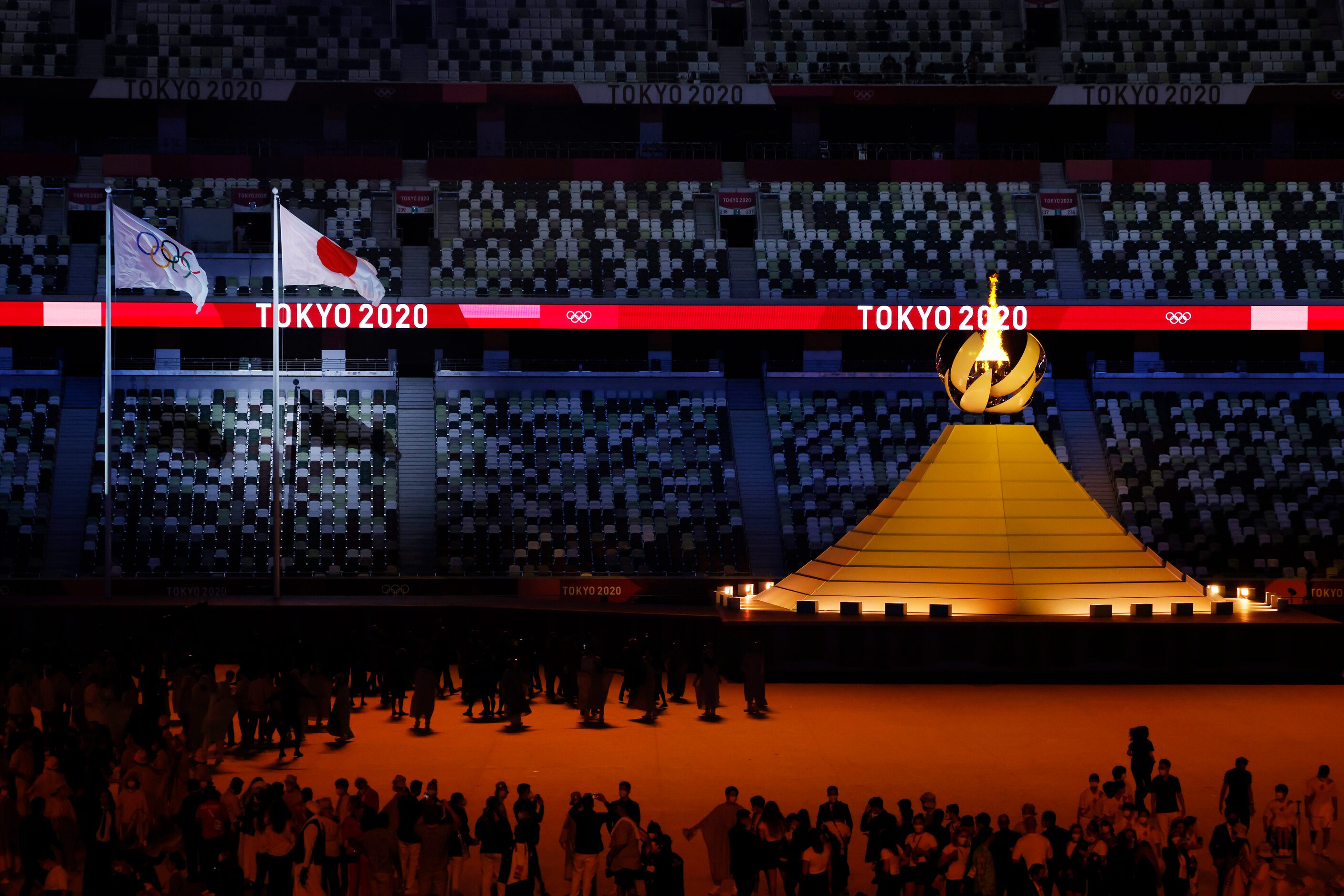 The Olympic cauldron is lit during the opening ceremony for the postponed 2020 Tokyo...