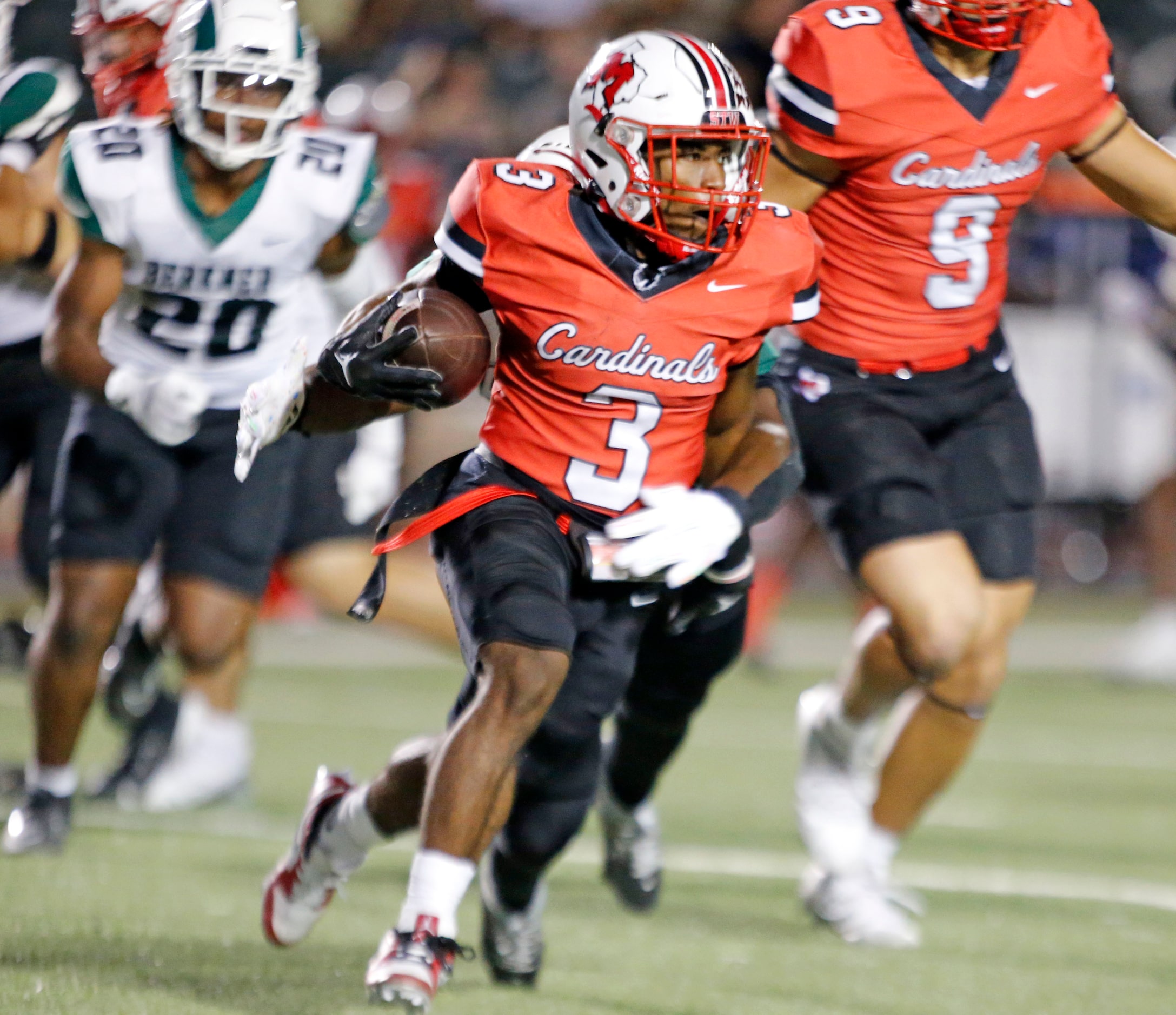 Irving MacArthur High’s Ray Corde (3) picks up a short gain during the first half of a high...