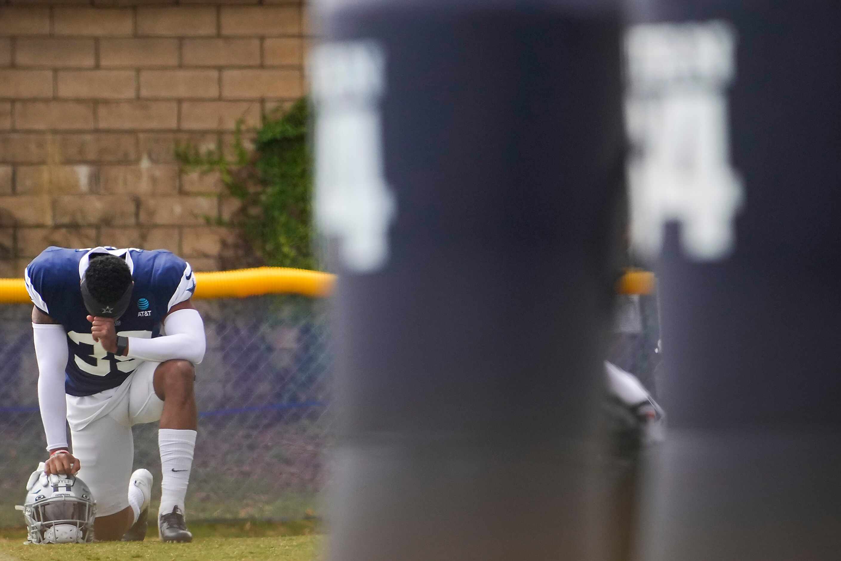 Dallas Cowboys safety Tyler Coyle takes a knee before a practice at training camp on...