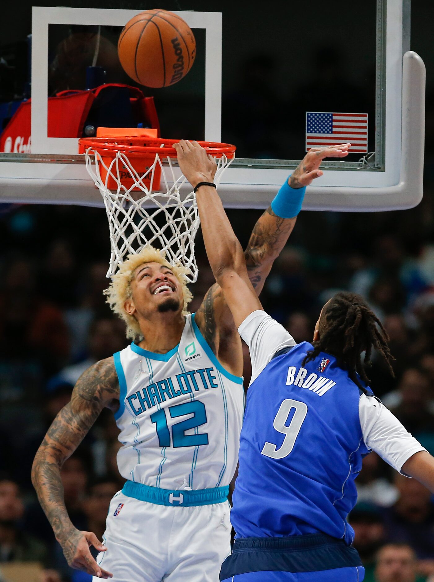 Dallas Mavericks center Moses Brown (9) attempts a dunk as Charlotte Hornets guard Kelly...