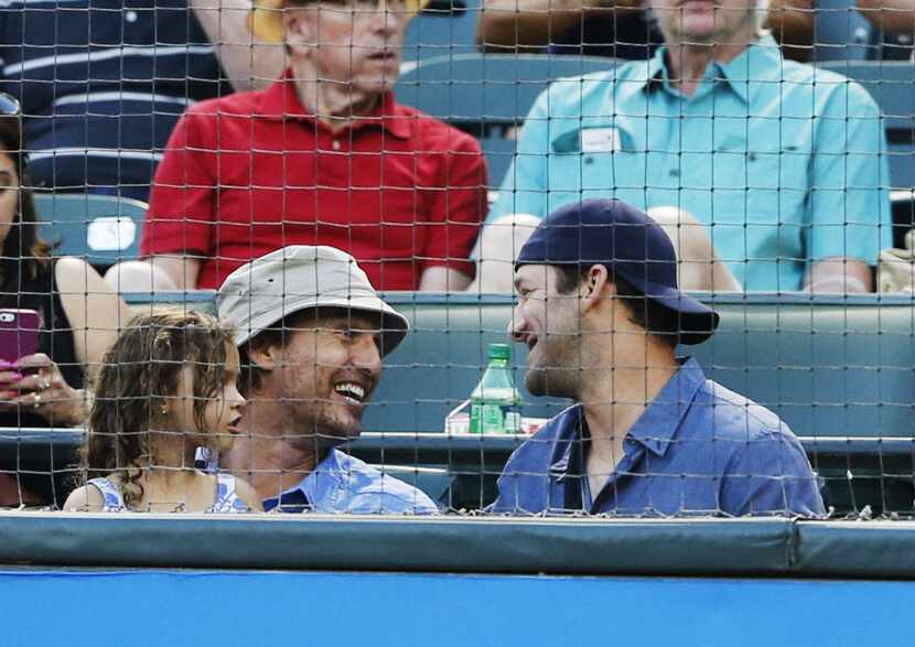 Actor Matthew McConaughey shares a laugh with Dallas Cowboys quarterback Tony Romo during...