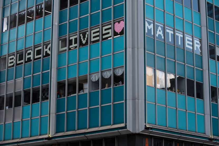 Pieces of paper spell out Black Lives Matters on the windows of a downtown Dallas building....