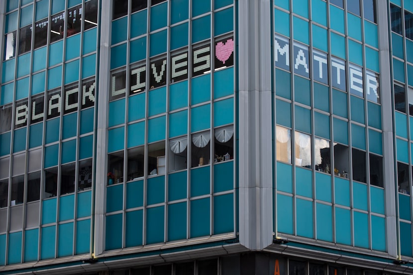 Pieces of paper spell out Black Lives Matters on the windows of a downtown Dallas building....