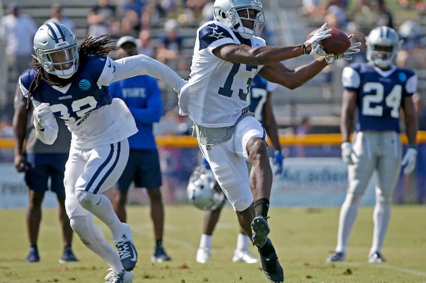 Dallas Cowboys wide receiver Michael Gallup, right, tries to catch a pass in front of...
