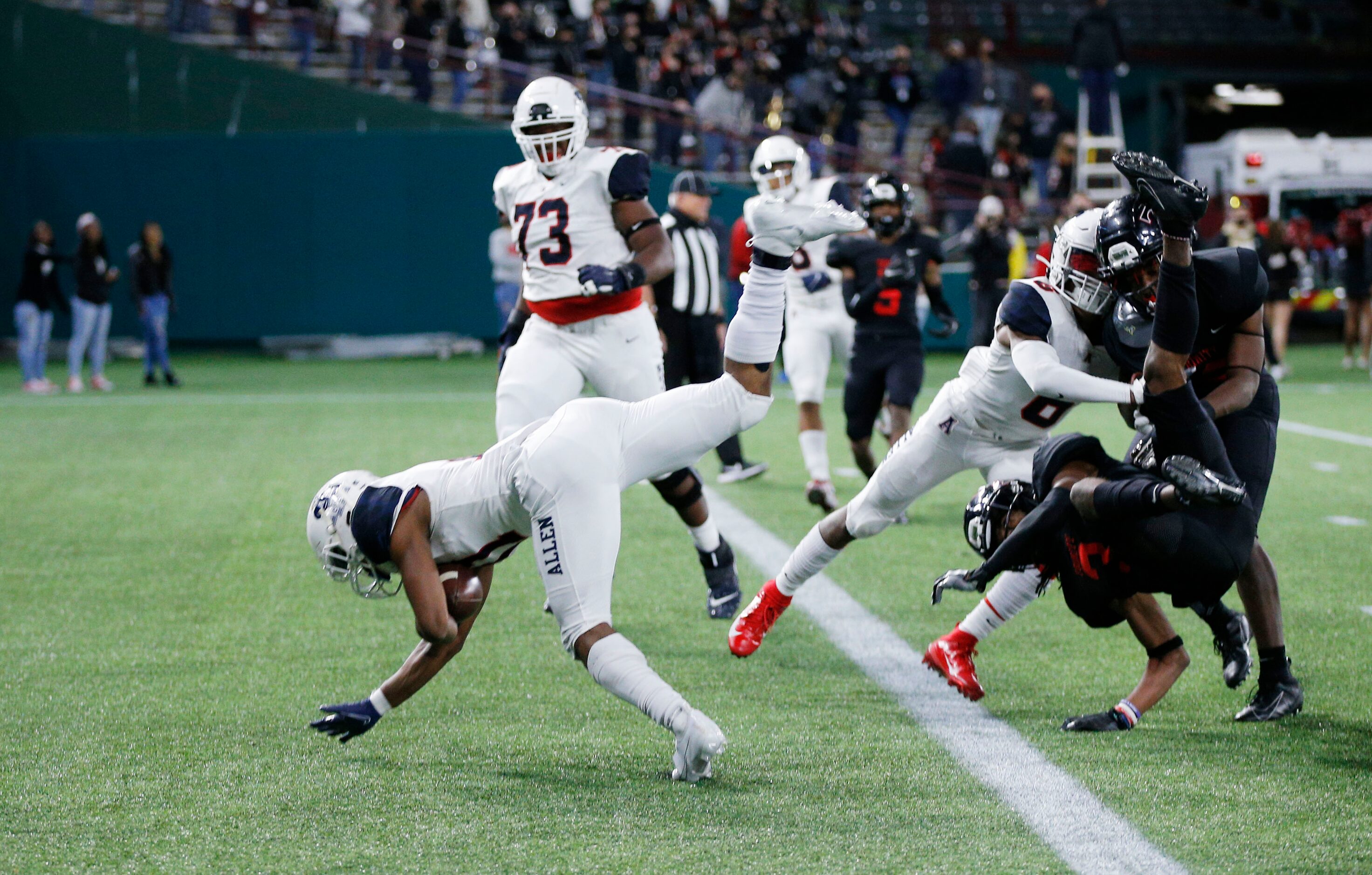 Allen senior vide receiver Jordan Johnson (11) leaps into the end zone for a touchdown...