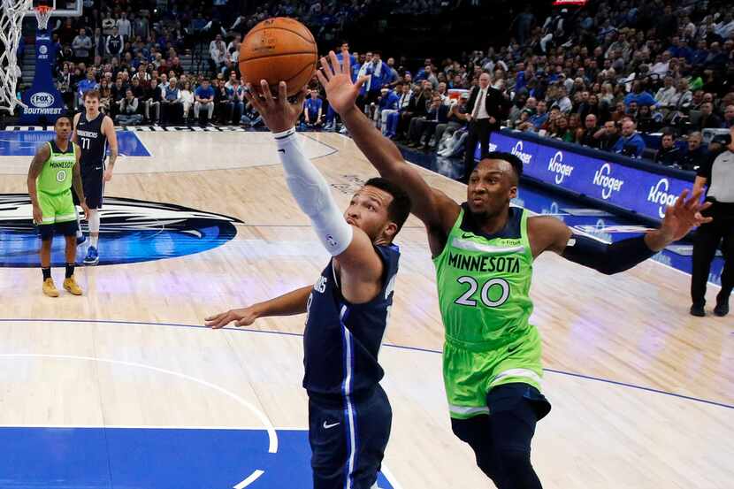 Dallas Mavericks guard Jalen Brunson (13) lays up a second half shot past Minnesota...